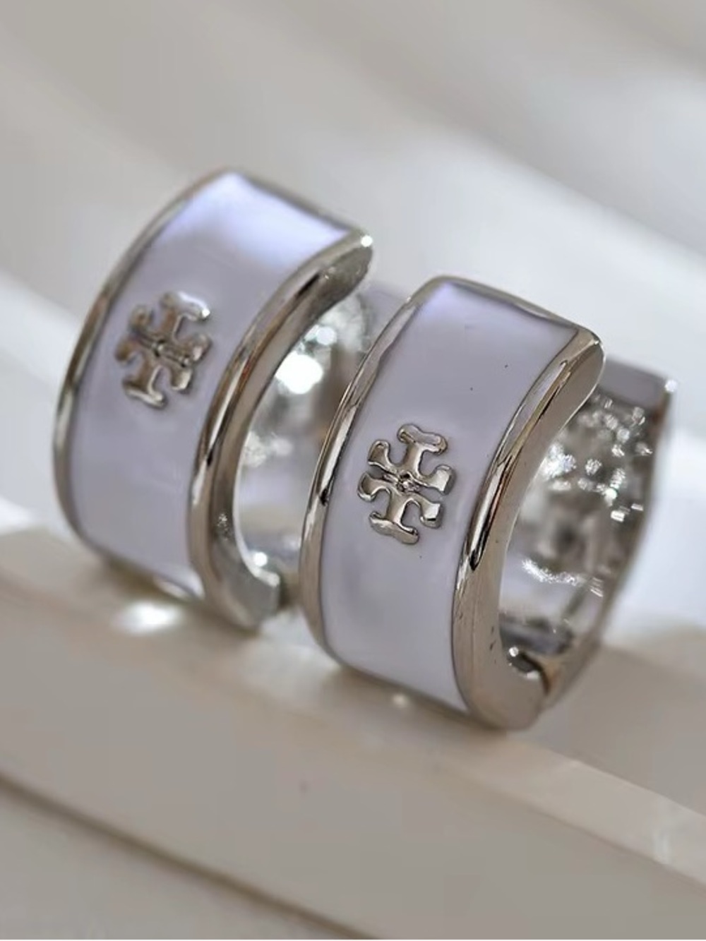 TORY BURCH SILVER + WHITE HUGGIE HOOP EARRINGS